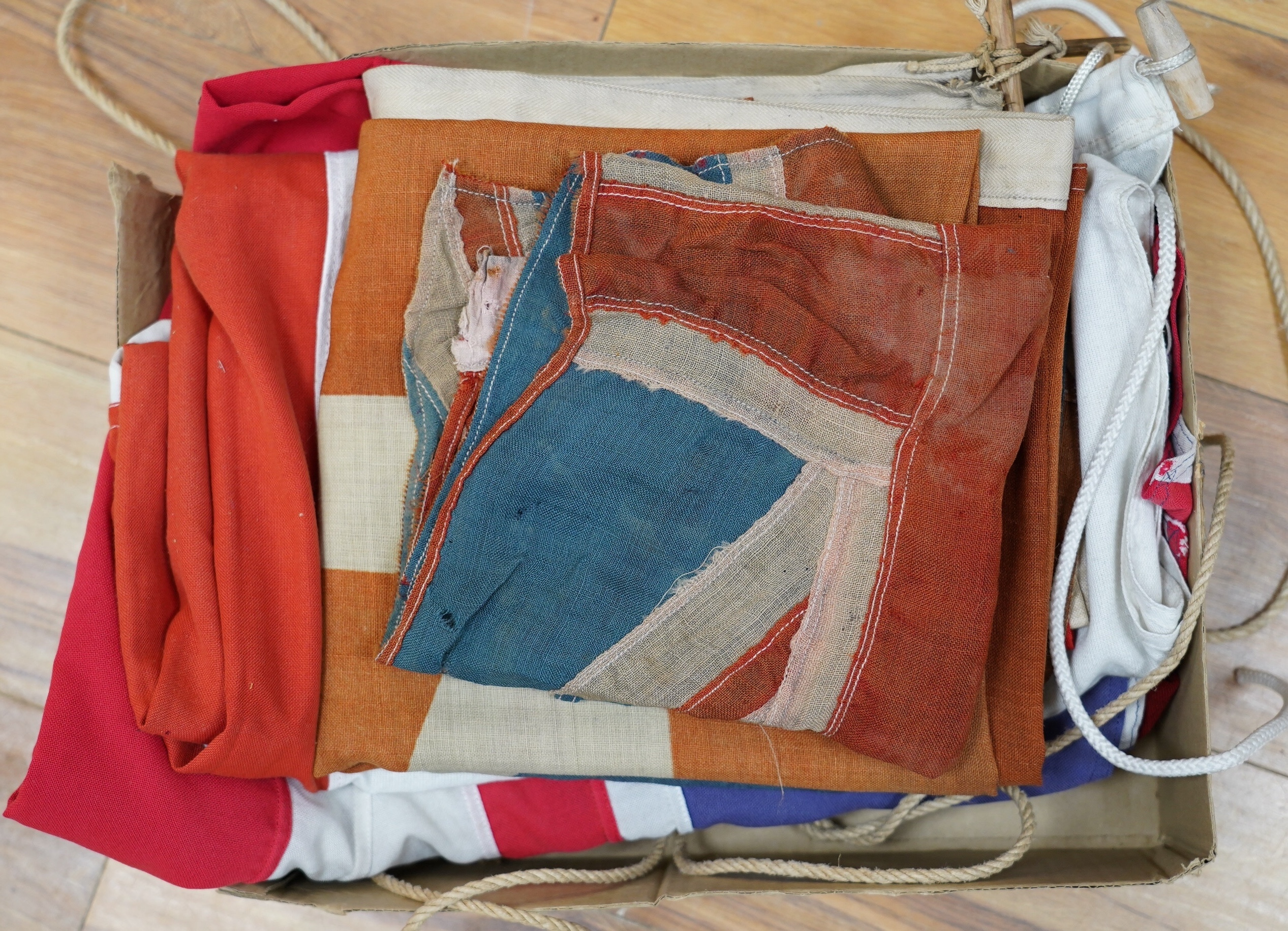 Eight mostly mid 20th century Union Jack flags, one celebrating Queen Victoria’s Diamond Jubilee, together with a Saint George’s cross and a string of Union flag bunting. Condition - poor to good